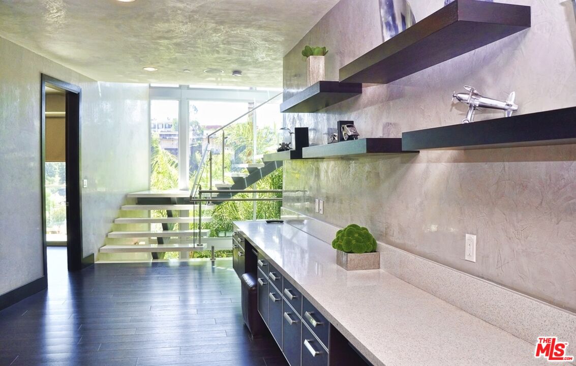 6425 Weidlake Drive Los Angeles, CA 90068 - Photo 26 of 37 a kitchen with stainless steel appliances granite countertop a sink a stove and wooden floors