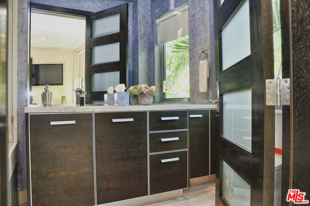 6425 Weidlake Drive Los Angeles, CA 90068 - Photo 28 of 37 a kitchen with stainless steel appliances granite countertop a refrigerator and a sink
