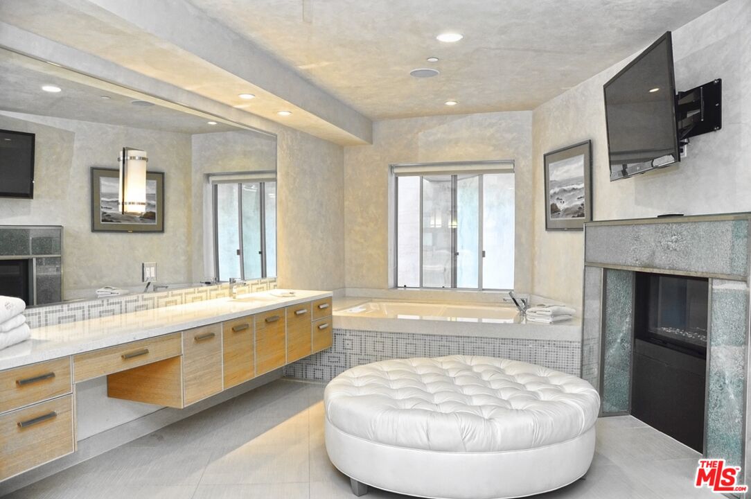6425 Weidlake Drive Los Angeles, CA 90068 - Photo 31 of 37 a bathroom with a tub sink and mirror