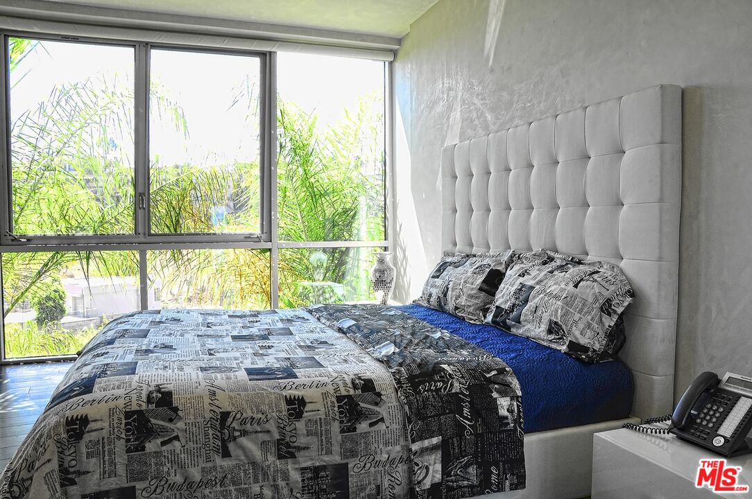 6425 Weidlake Drive Los Angeles, CA 90068 - Photo 34 of 37 a bed sitting in a bedroom next to a window