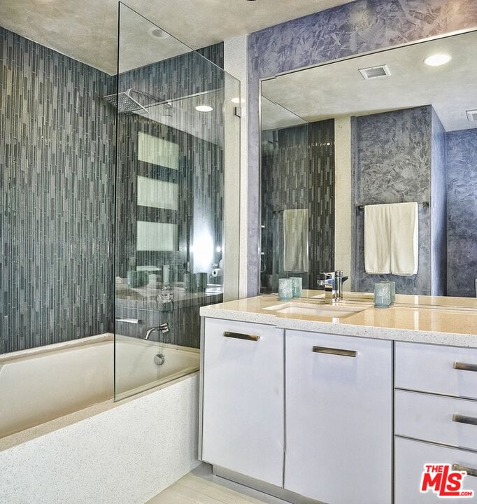 6425 Weidlake Drive Los Angeles, CA 90068 - Photo 35 of 37 a bathroom with a tub sink and mirror