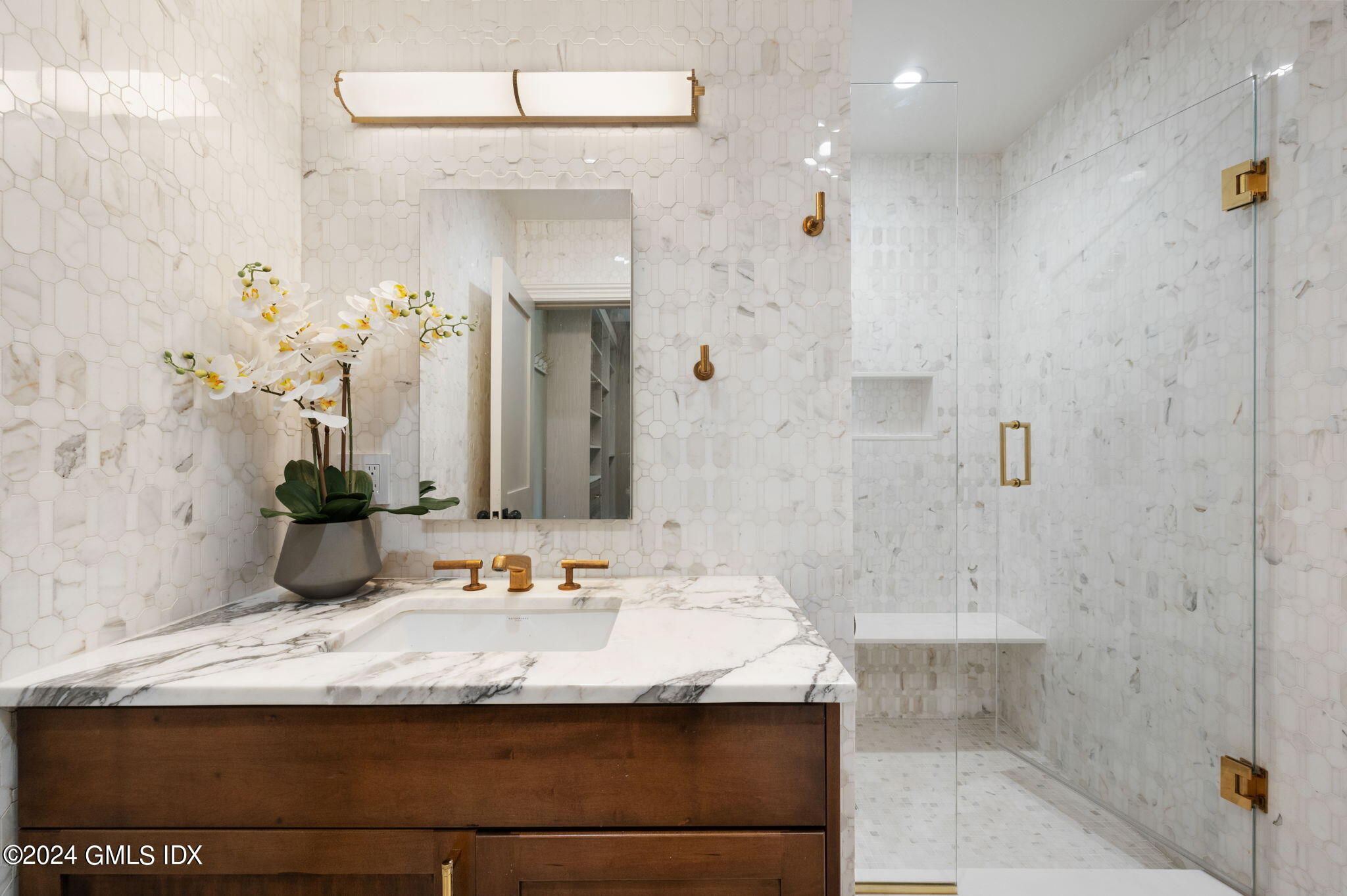 20 Church Street, Unit B11 Greenwich, CT 06830 - Photo 12 of 23 a bathroom with a granite countertop sink a mirror and shower