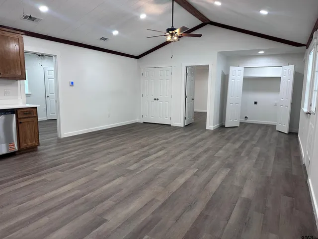a view of empty room with wooden floor