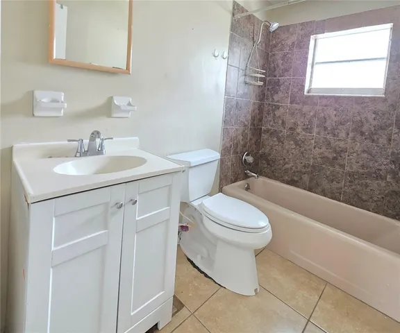 a bathroom with a sink a toilet a bathtub and shower