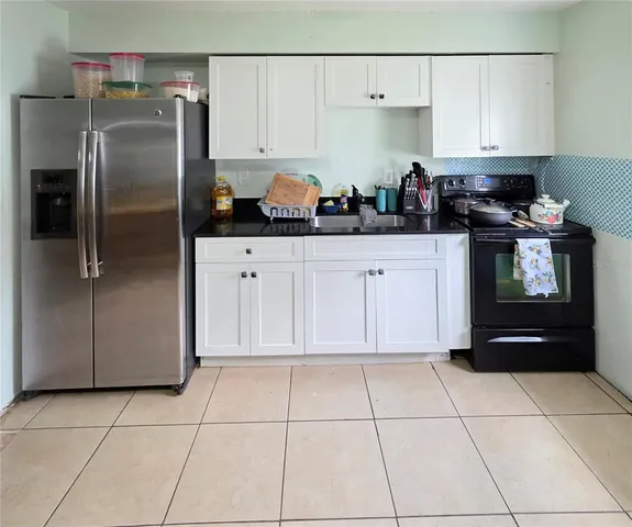 a kitchen with stainless steel appliances a refrigerator sink and cabinets