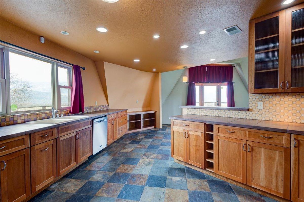 41622 Blue Oak Drive Springville, CA 93265 - Photo 13 of 68 a kitchen with stainless steel appliances granite countertop a stove a sink and a microwave