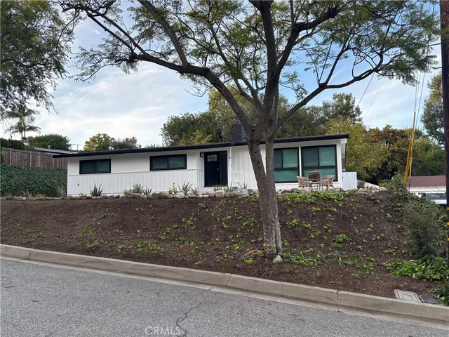 front view of a house with a tree