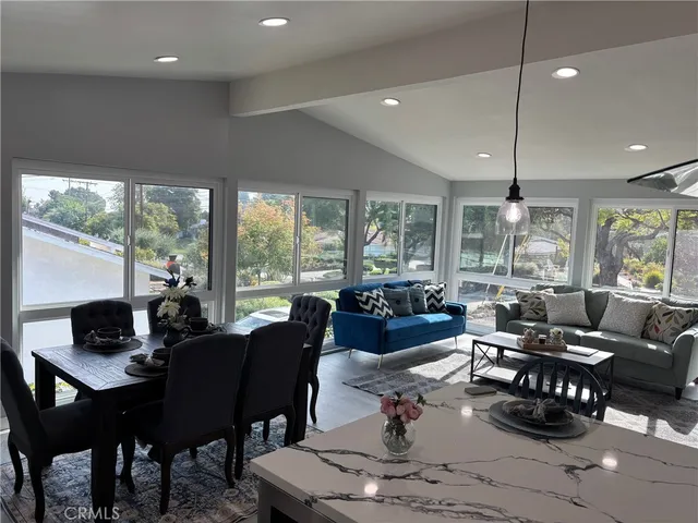 a living room with lots of furniture and a large window