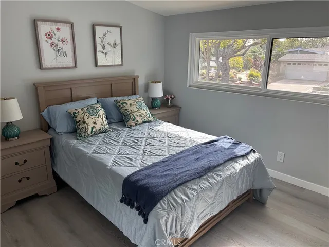 a bed sitting in a bedroom next to a window