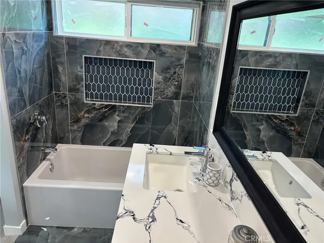 a bathroom with a bathtub and sink