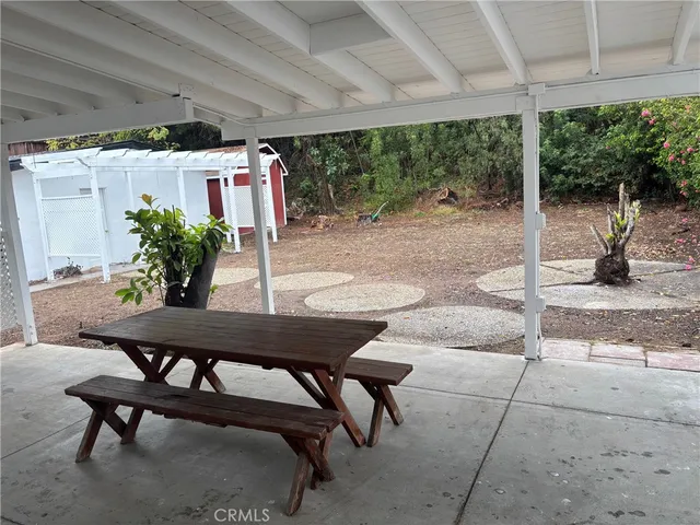 a view of a patio with table and chairs potted plants with wooden floor