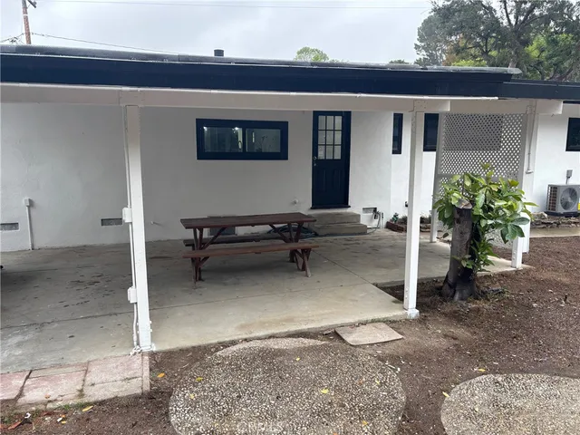 a backyard of a house with outdoor seating