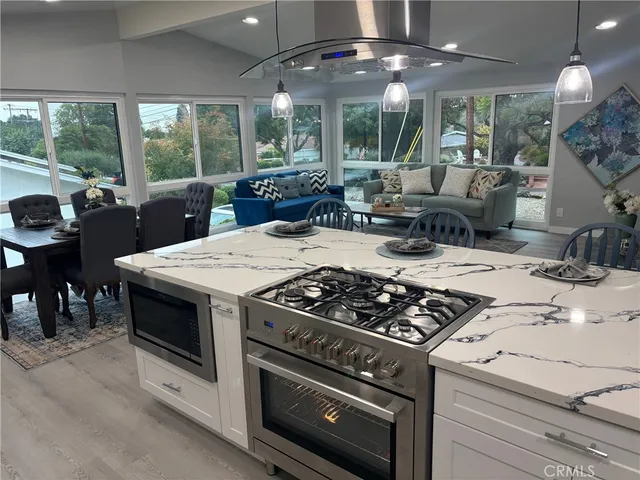 a kitchen with a stove a microwave and wooden floor