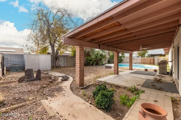 a backyard of a house with basket ball court and outdoor seating