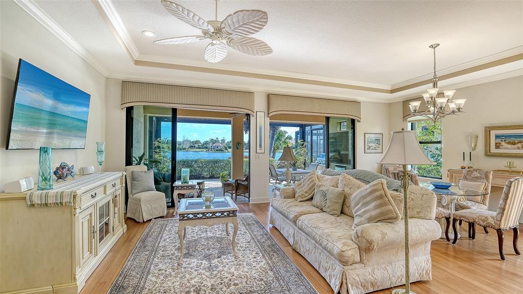 12759 Del Corso Loop Bradenton, FL 34211 - Photo 11 of 74 a living room with furniture a chandelier and a large window