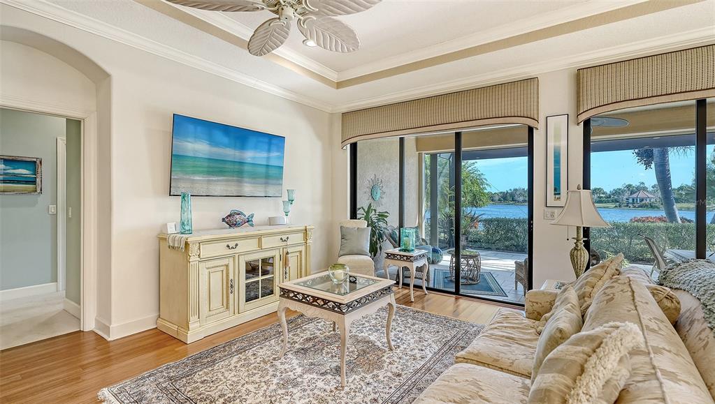 12759 Del Corso Loop Bradenton, FL 34211 - Photo 13 of 74 a living room with furniture a flat screen tv and a floor to ceiling window