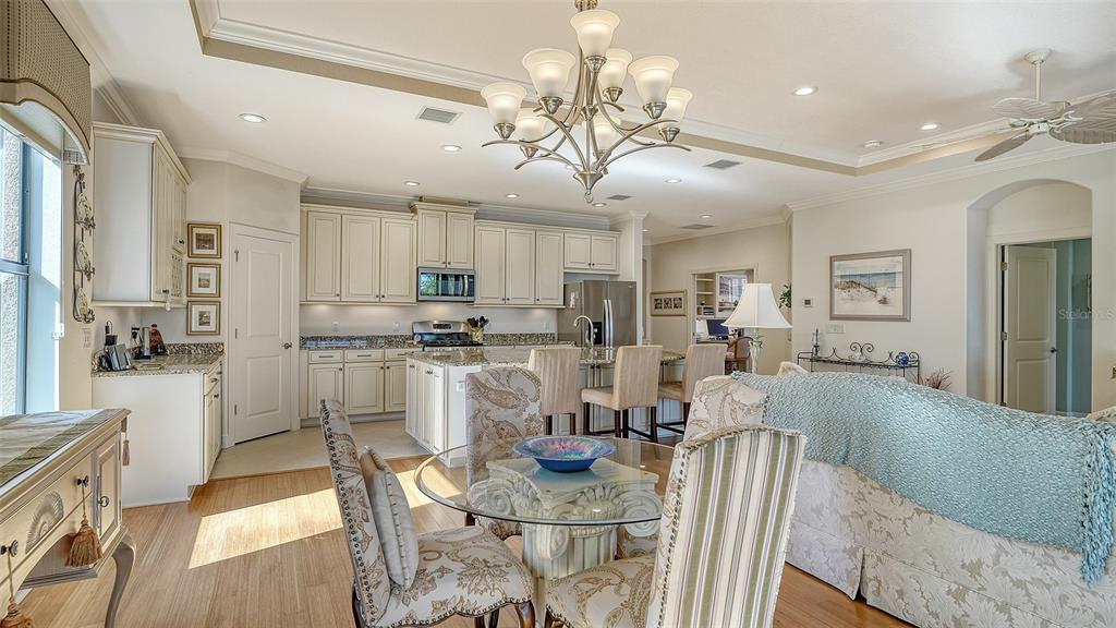 12759 Del Corso Loop Bradenton, FL 34211 - Photo 14 of 74 a view of a dining room and livingroom with furniture wooden floor and a chandelier