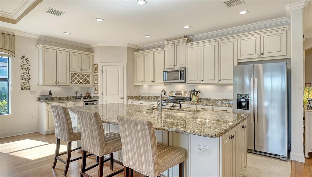 12759 Del Corso Loop Bradenton, FL 34211 - Photo 15 of 74 a kitchen with kitchen island granite countertop stainless steel appliances cabinets a sink and a island
