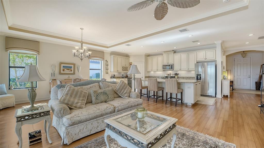 12759 Del Corso Loop Bradenton, FL 34211 - Photo 16 of 74 a living room with furniture and kitchen view