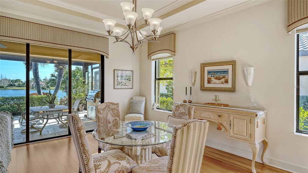 12759 Del Corso Loop Bradenton, FL 34211 - Photo 18 of 74 a view of a dining room with furniture a chandelier and large windows