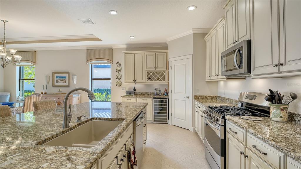 12759 Del Corso Loop Bradenton, FL 34211 - Photo 21 of 74 a kitchen with stainless steel appliances granite countertop a sink stove and cabinets