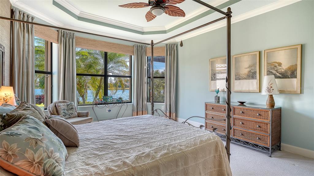 12759 Del Corso Loop Bradenton, FL 34211 - Photo 24 of 74 a bedroom with a bed window and a chandelier