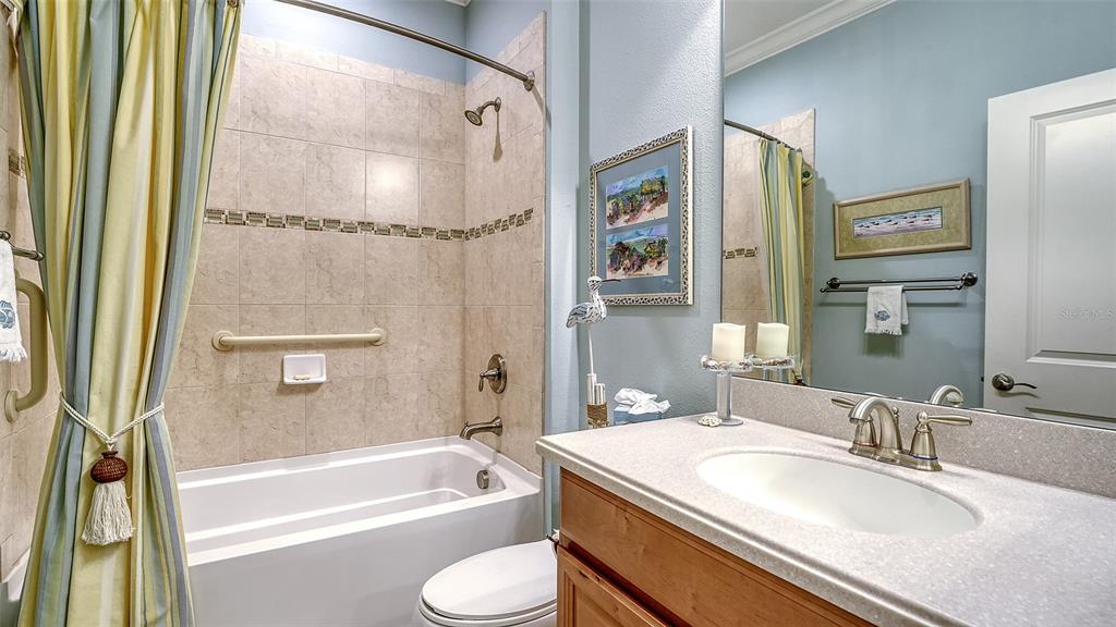 12759 Del Corso Loop Bradenton, FL 34211 - Photo 34 of 74 a bathroom with a granite countertop sink mirror toilet and bathtub