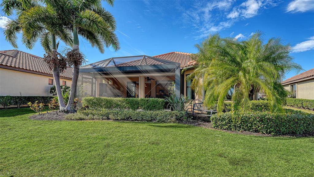 12759 Del Corso Loop Bradenton, FL 34211 - Photo 46 of 74 a front view of a house with a garden