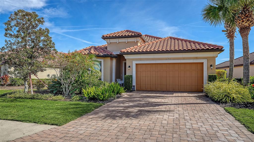 12759 Del Corso Loop Bradenton, FL 34211 - Photo 7 of 74 a front view of a house with garden