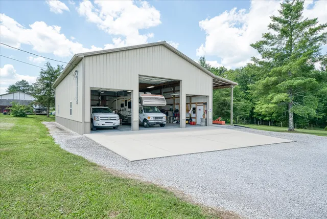 a view of a house with backyard and a garden