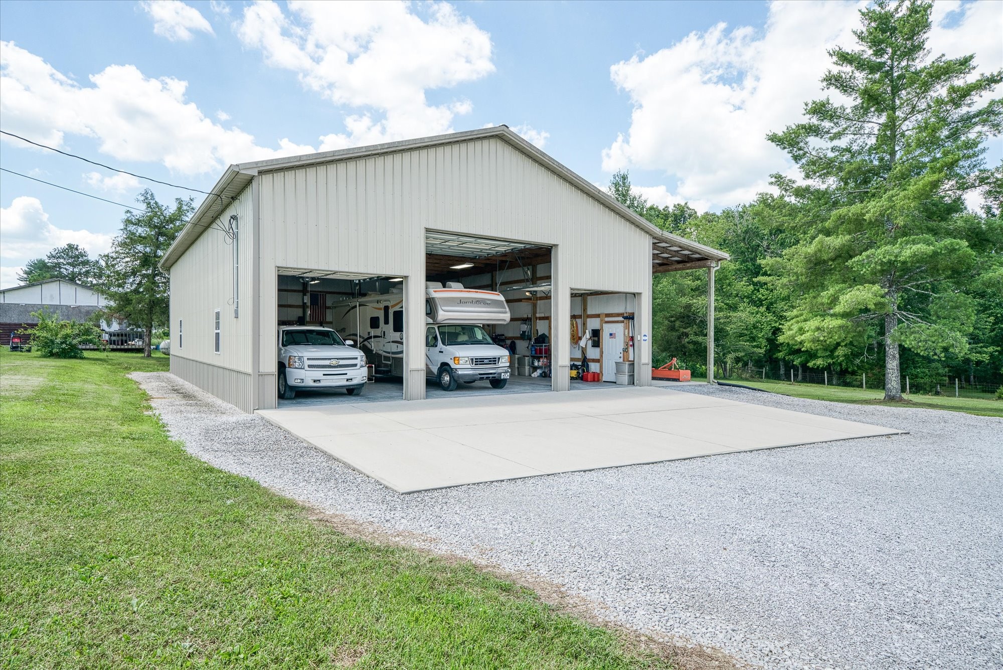 125 Clarence Lee Road Lancing, TN 37770 - Photo 21 of 55 a view of a house with backyard and a garden
