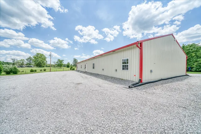 a backyard of a house with table and chairs