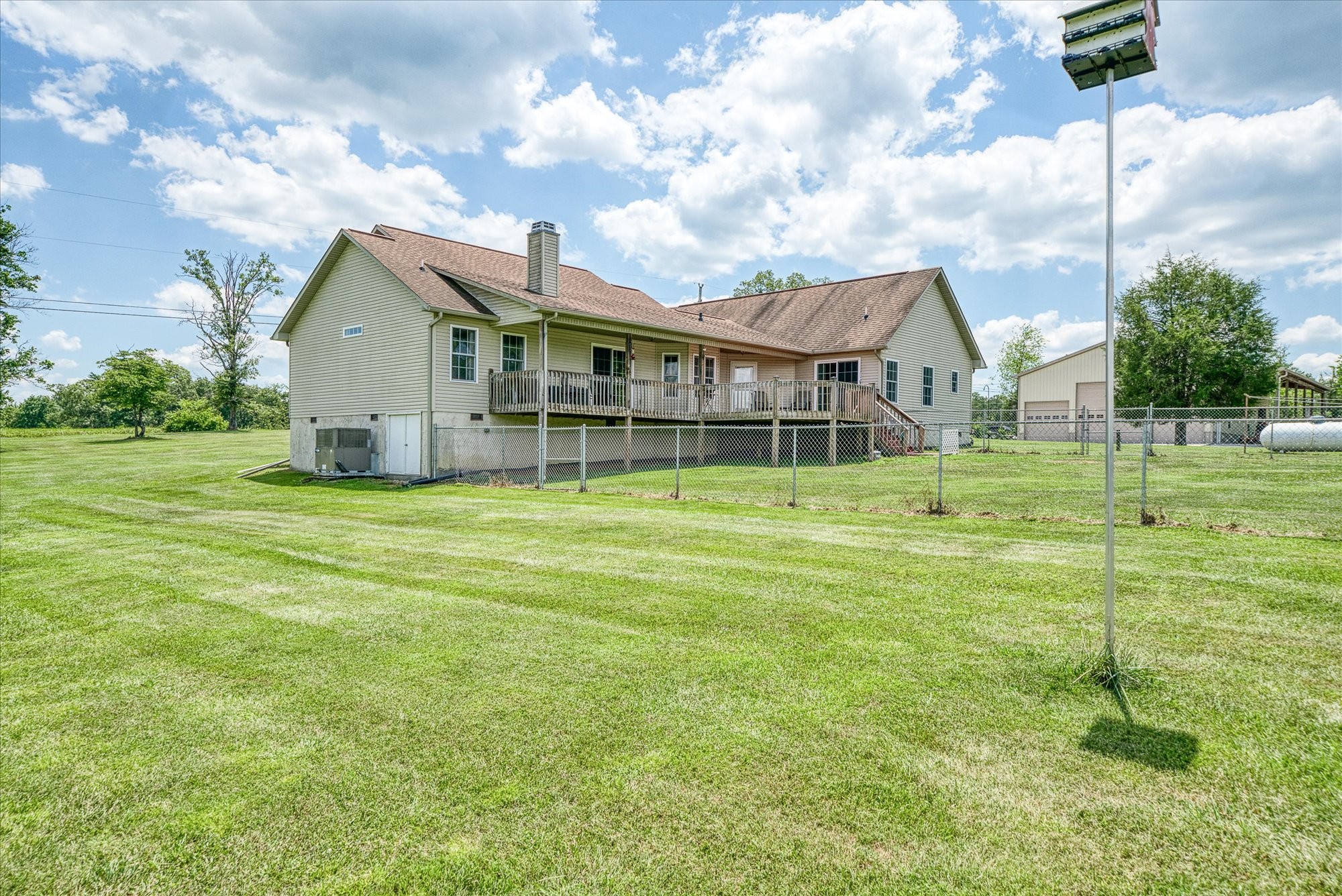 125 Clarence Lee Road Lancing, TN 37770 - Photo 40 of 55 a view of a house with a big yard and a large tree