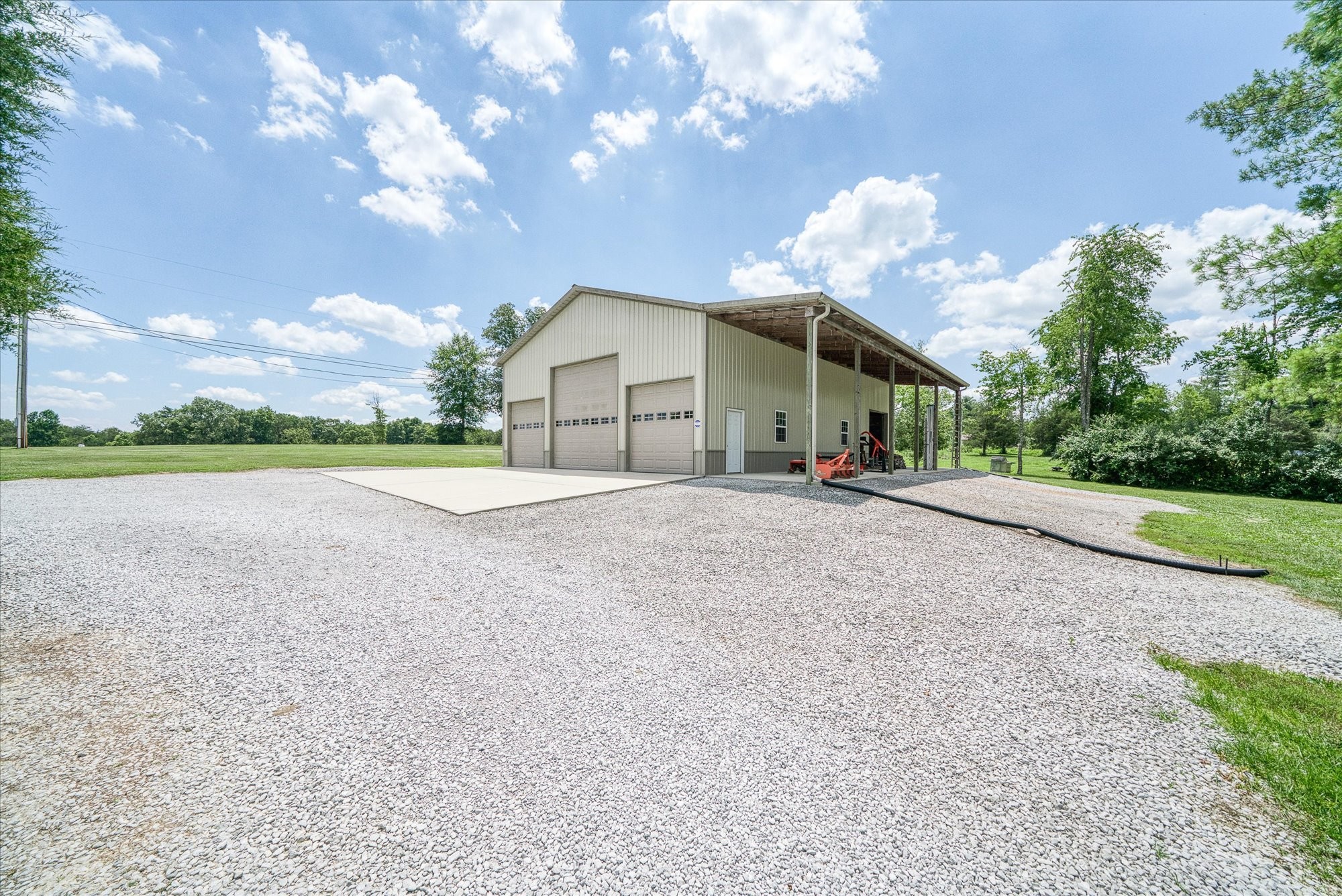 125 Clarence Lee Road Lancing, TN 37770 - Photo 44 of 55 a view of a house with a yard and a large tree