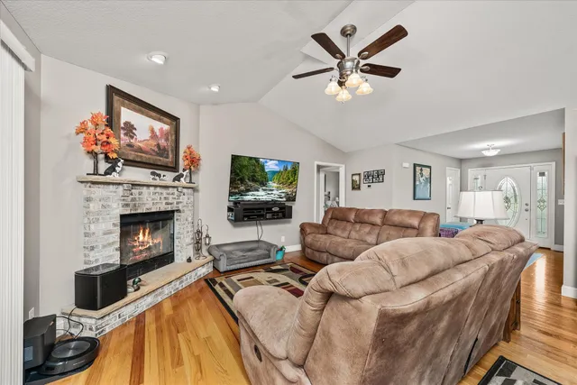 a living room with furniture a fireplace and a flat screen tv