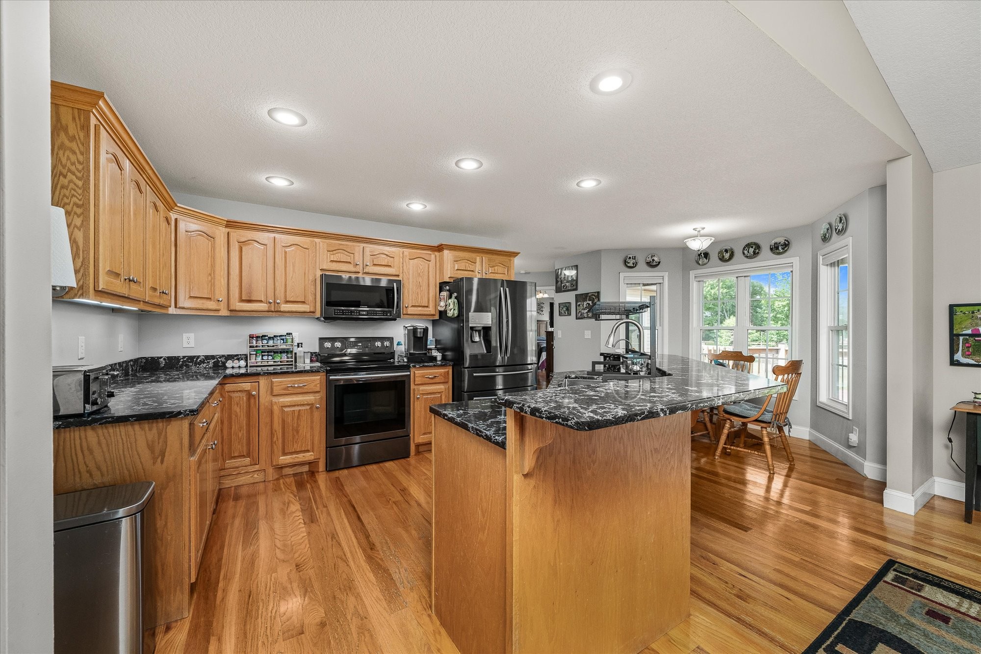 125 Clarence Lee Road Lancing, TN 37770 - Photo 7 of 55 a kitchen with stainless steel appliances kitchen island granite countertop a stove and cabinets