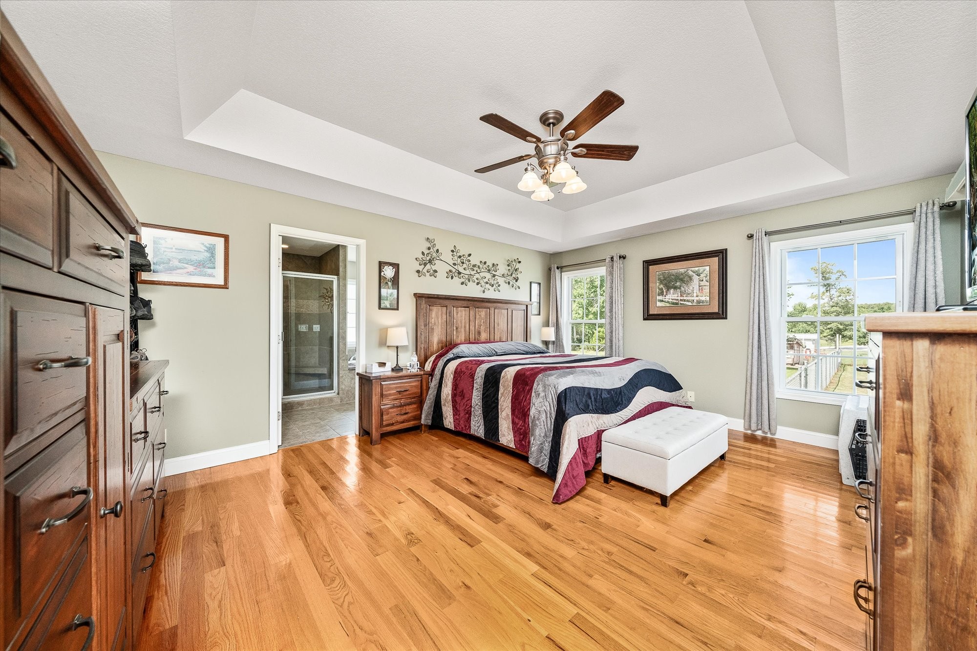 125 Clarence Lee Road Lancing, TN 37770 - Photo 10 of 55 a spacious bedroom with a bed and a chandelier