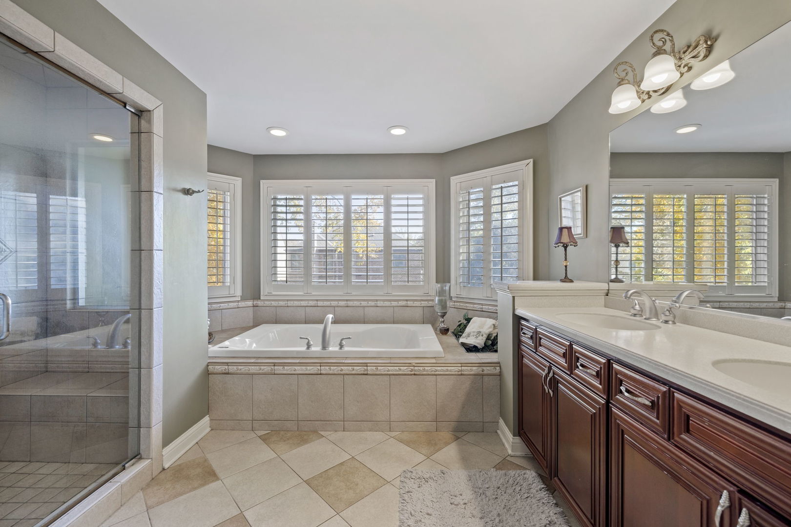 611 Fairfield Avenue Elmhurst, IL 60126 - Photo 25 of 44 a spacious bathroom with a double vanity sink a mirror and a bathtub