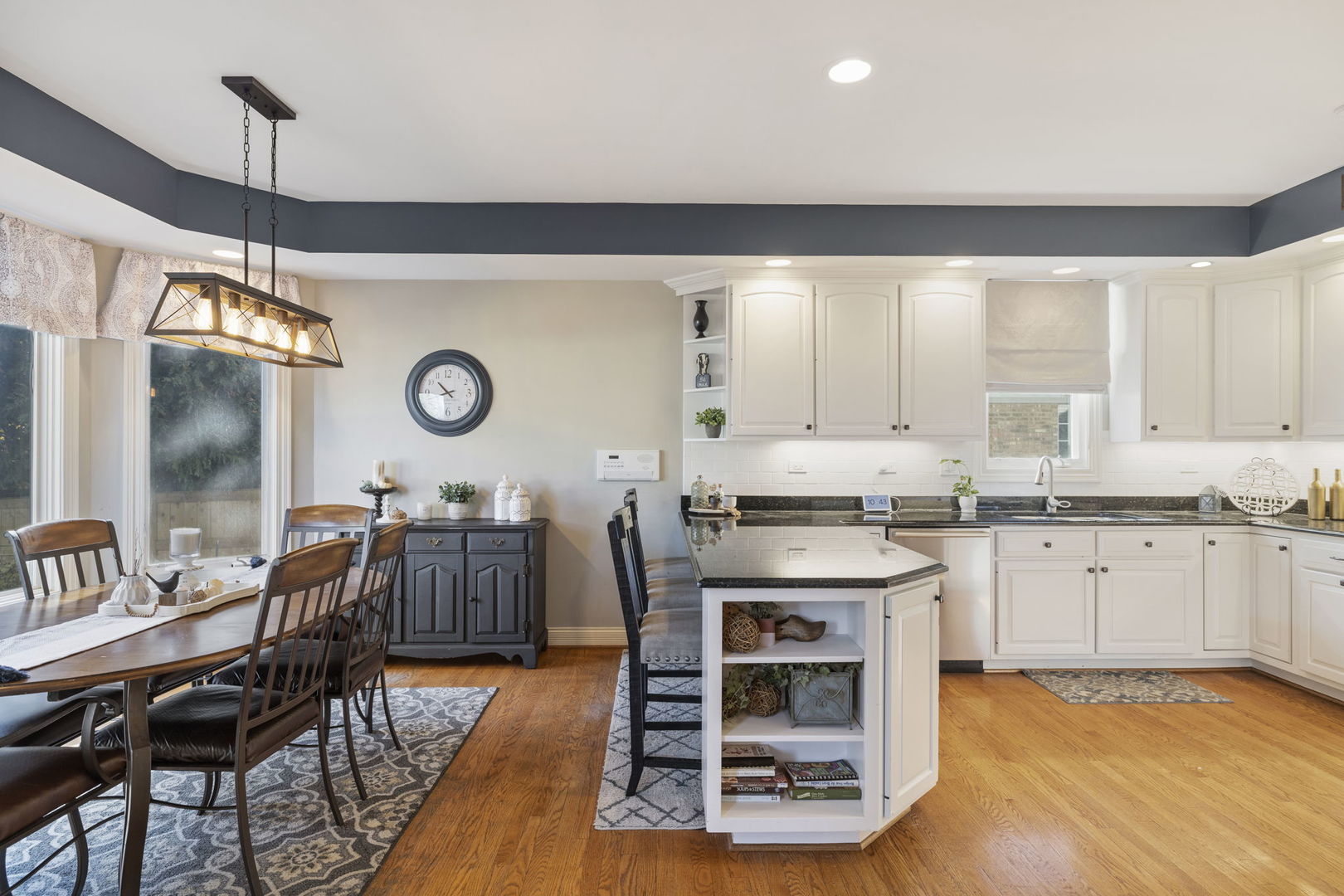 611 Fairfield Avenue Elmhurst, IL 60126 - Photo 10 of 44 a kitchen with granite countertop a stove a sink a dining table and chairs with wooden floor