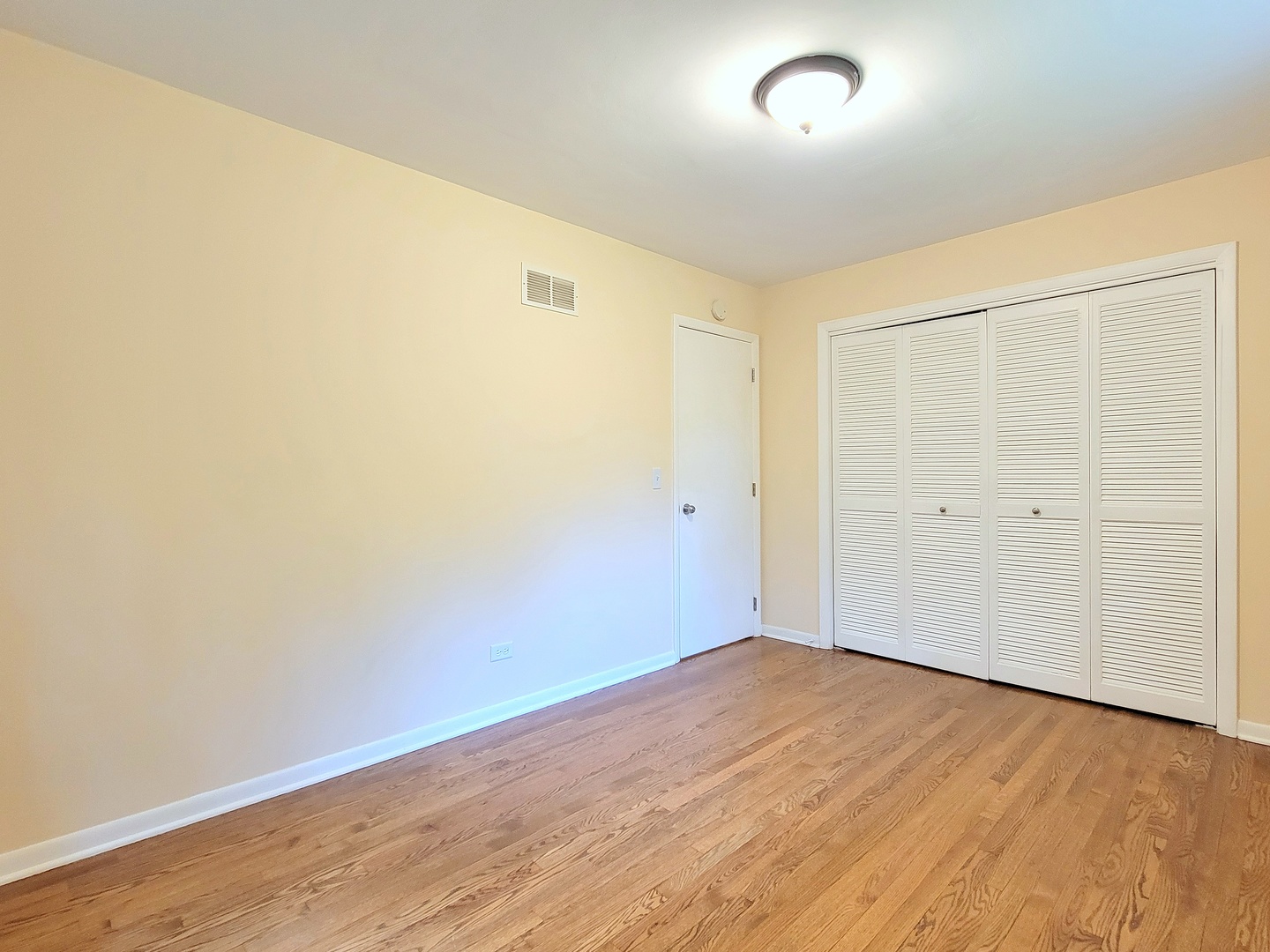 26W153 Jewell Road Wheaton, IL 60187 - Photo 12 of 35 an empty room with wooden floor and windows