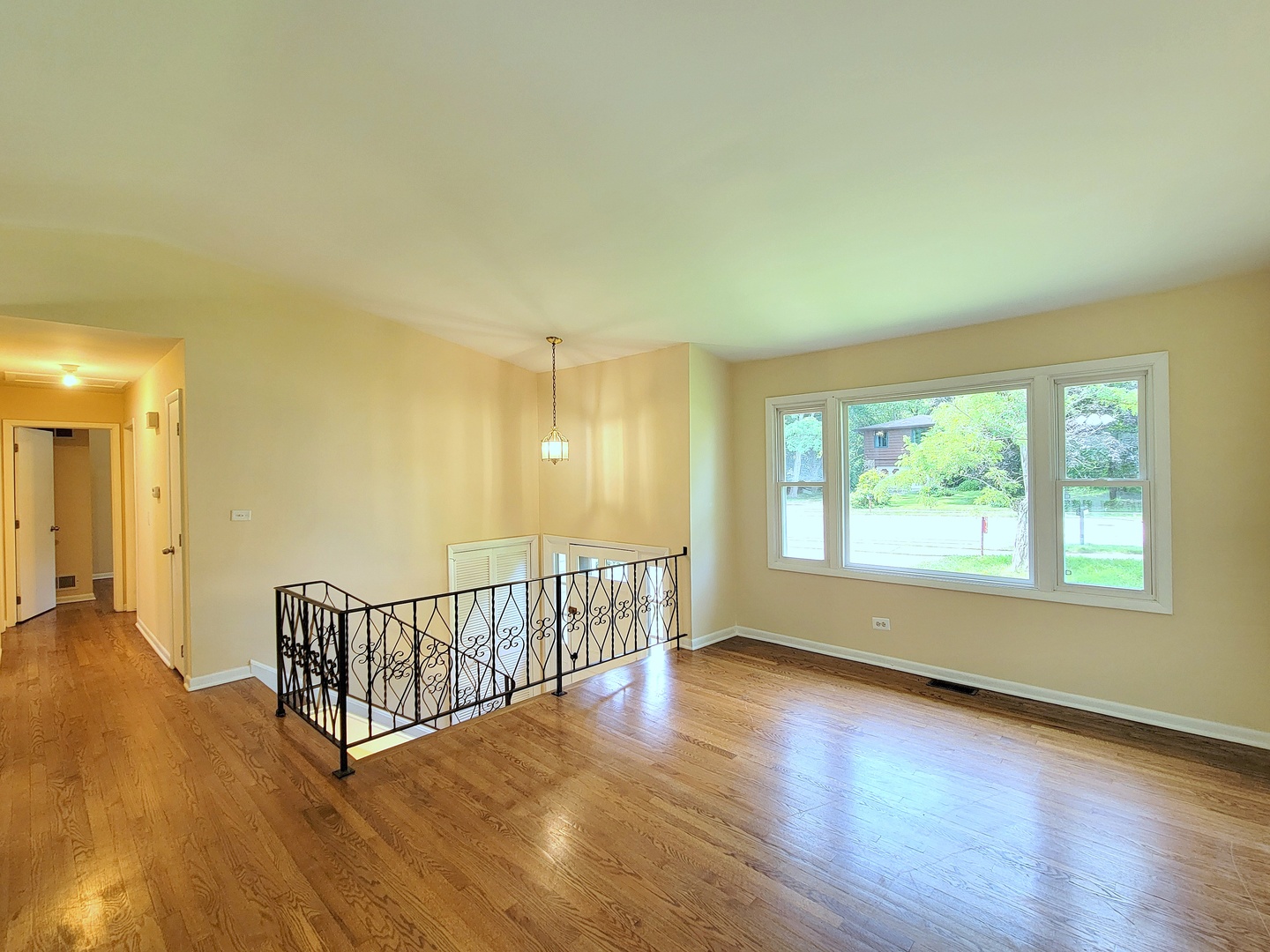 26W153 Jewell Road Wheaton, IL 60187 - Photo 4 of 35 a view of an empty room with wooden floor and a window