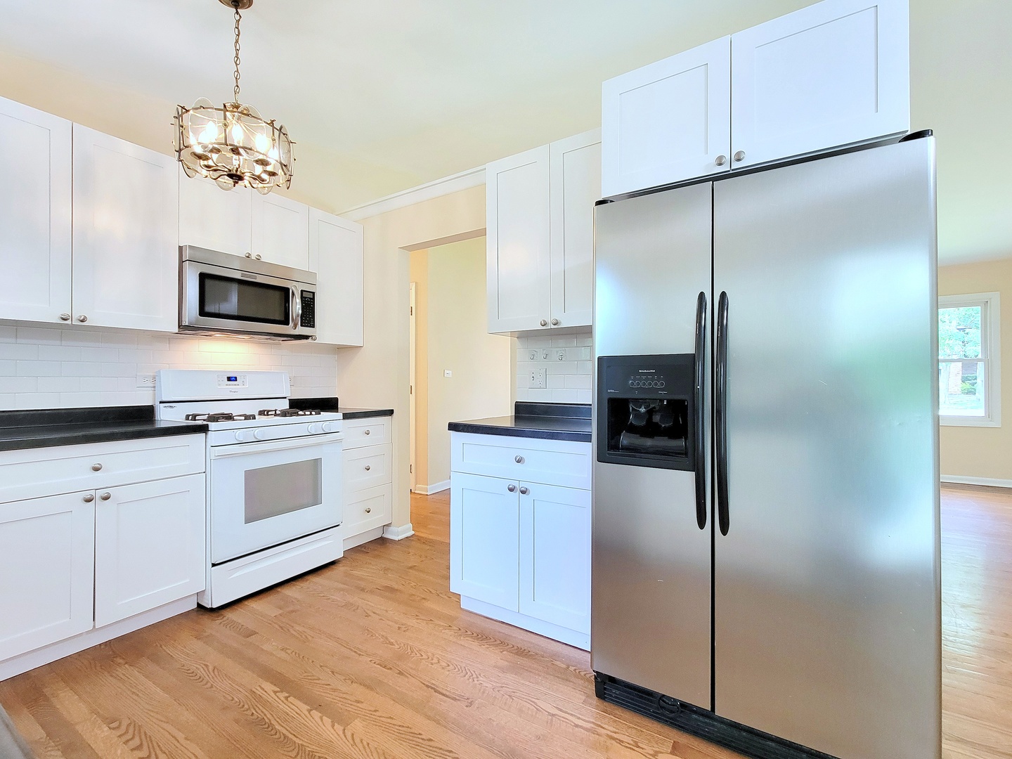 26W153 Jewell Road Wheaton, IL 60187 - Photo 7 of 35 a kitchen with a refrigerator stove and microwave