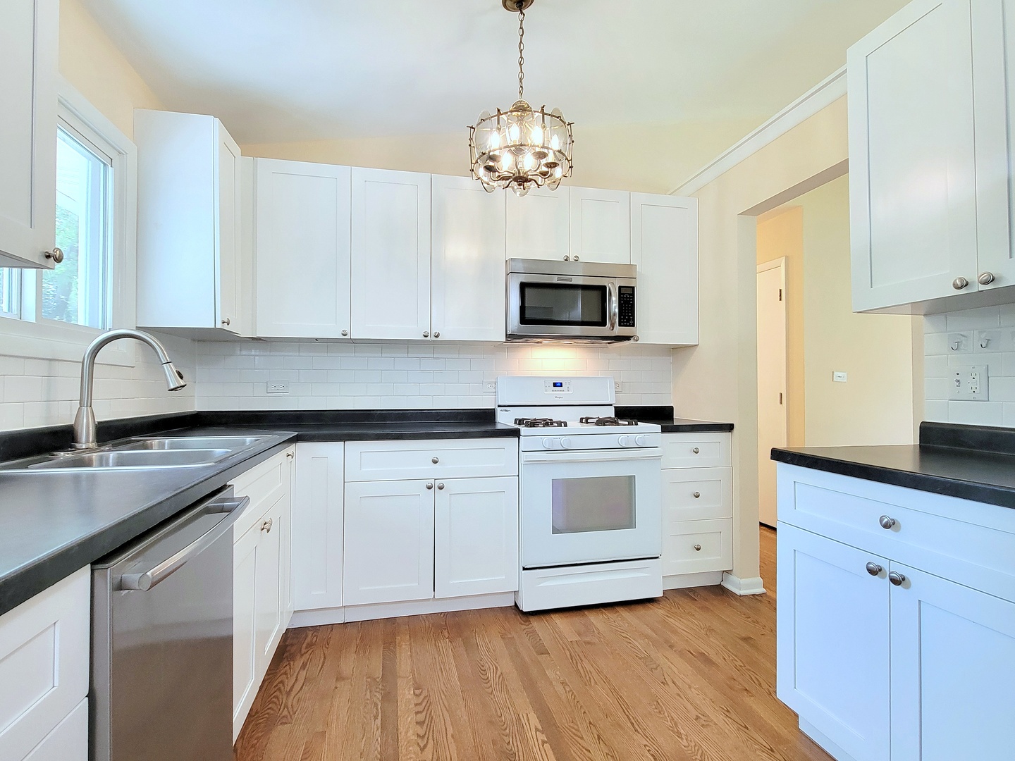 26W153 Jewell Road Wheaton, IL 60187 - Photo 8 of 35 a kitchen with stainless steel appliances granite countertop a sink a stove and microwave
