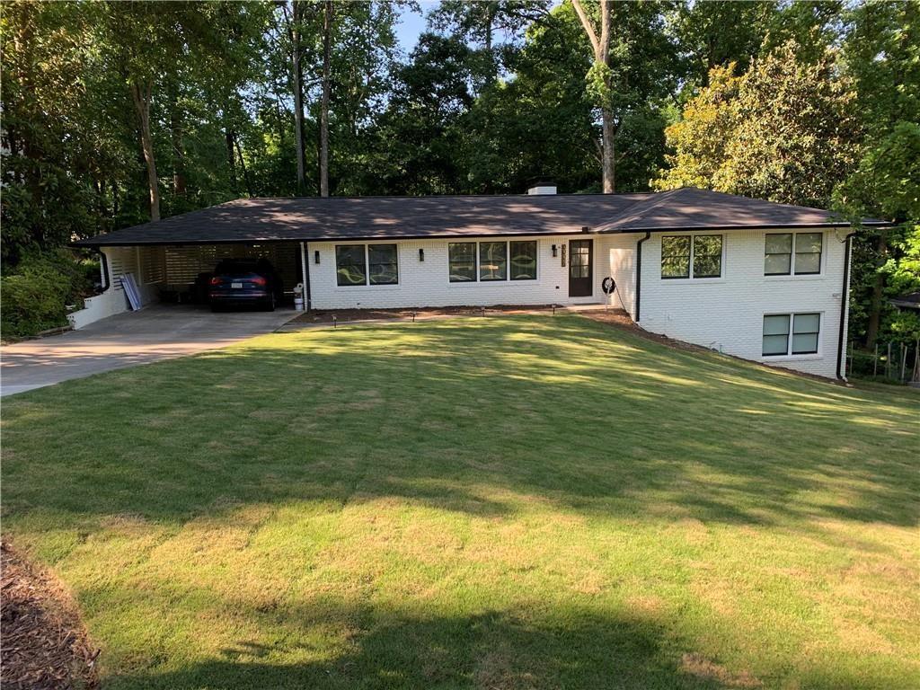 a front view of a house with a garden