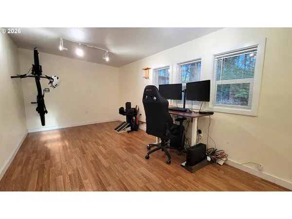 a park view with large trees and wooden fence