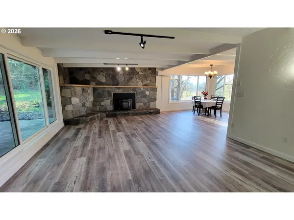 a kitchen with a dining table chairs and granite counter top