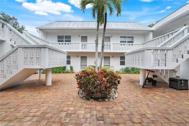 a front view of a building with sitting area