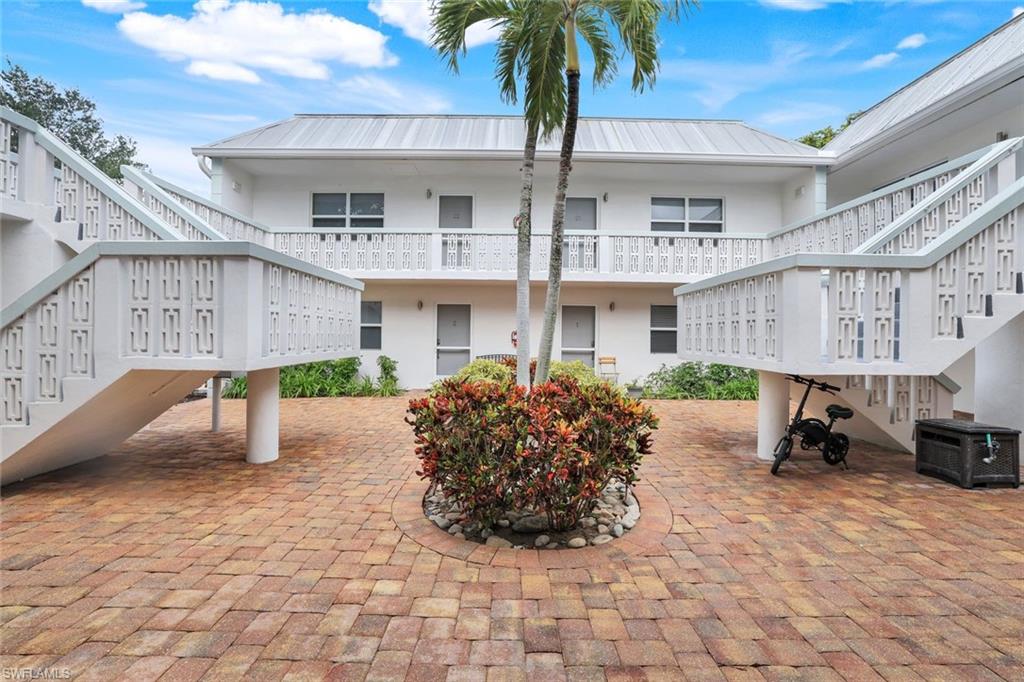 a front view of a building with sitting area