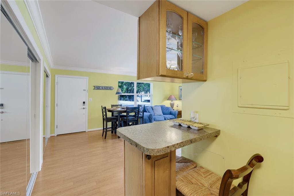 780 10th Avenue South, Unit 22 Naples, FL 34102 - Photo 11 of 17 a bathroom with a sink a table and a mirror