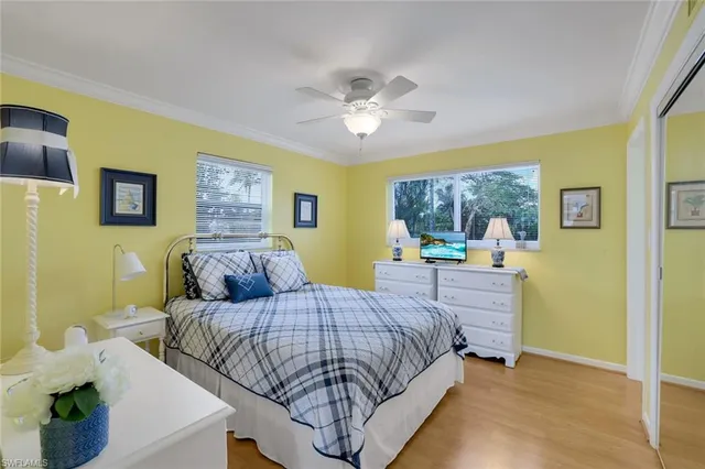 a bedroom with a bed and ceiling fan